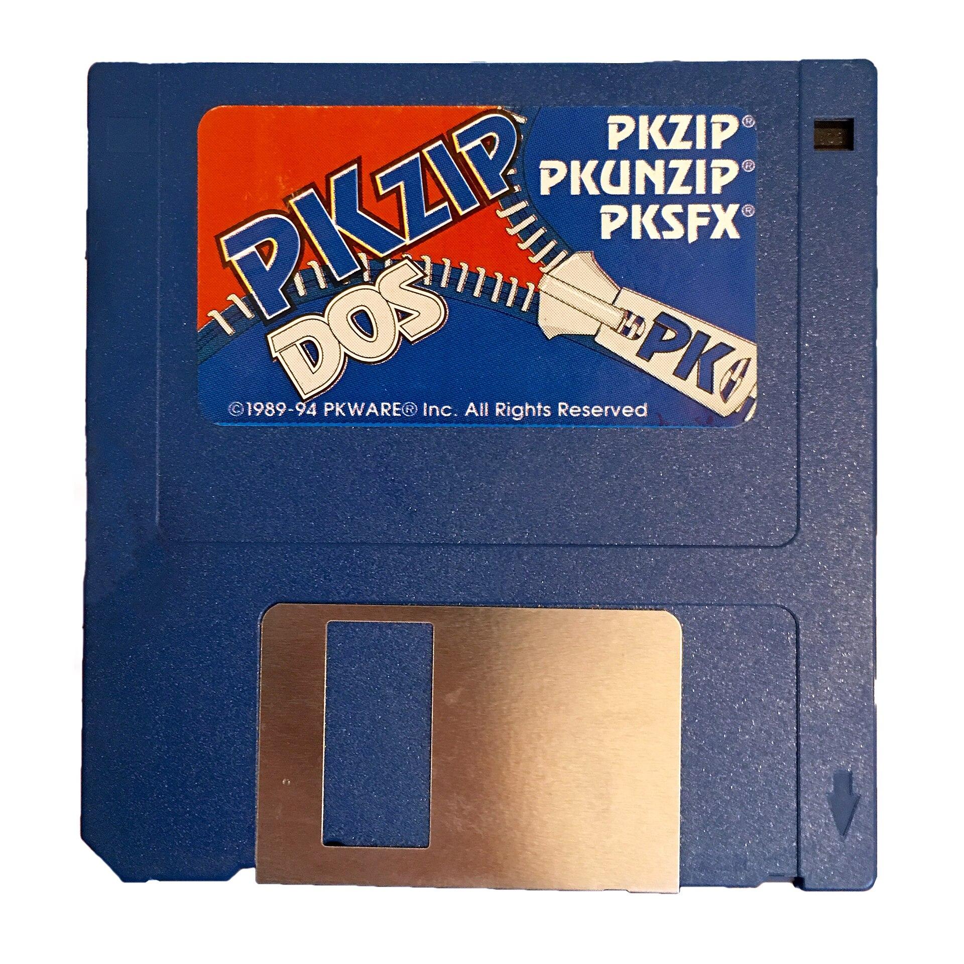 Blue 3.5-inch floppy disk with a PKZIP DOS label reading PKZIP, PKUNZIP and PKSFX, with zipper artwork and a copyright line dated 1989 to 1994