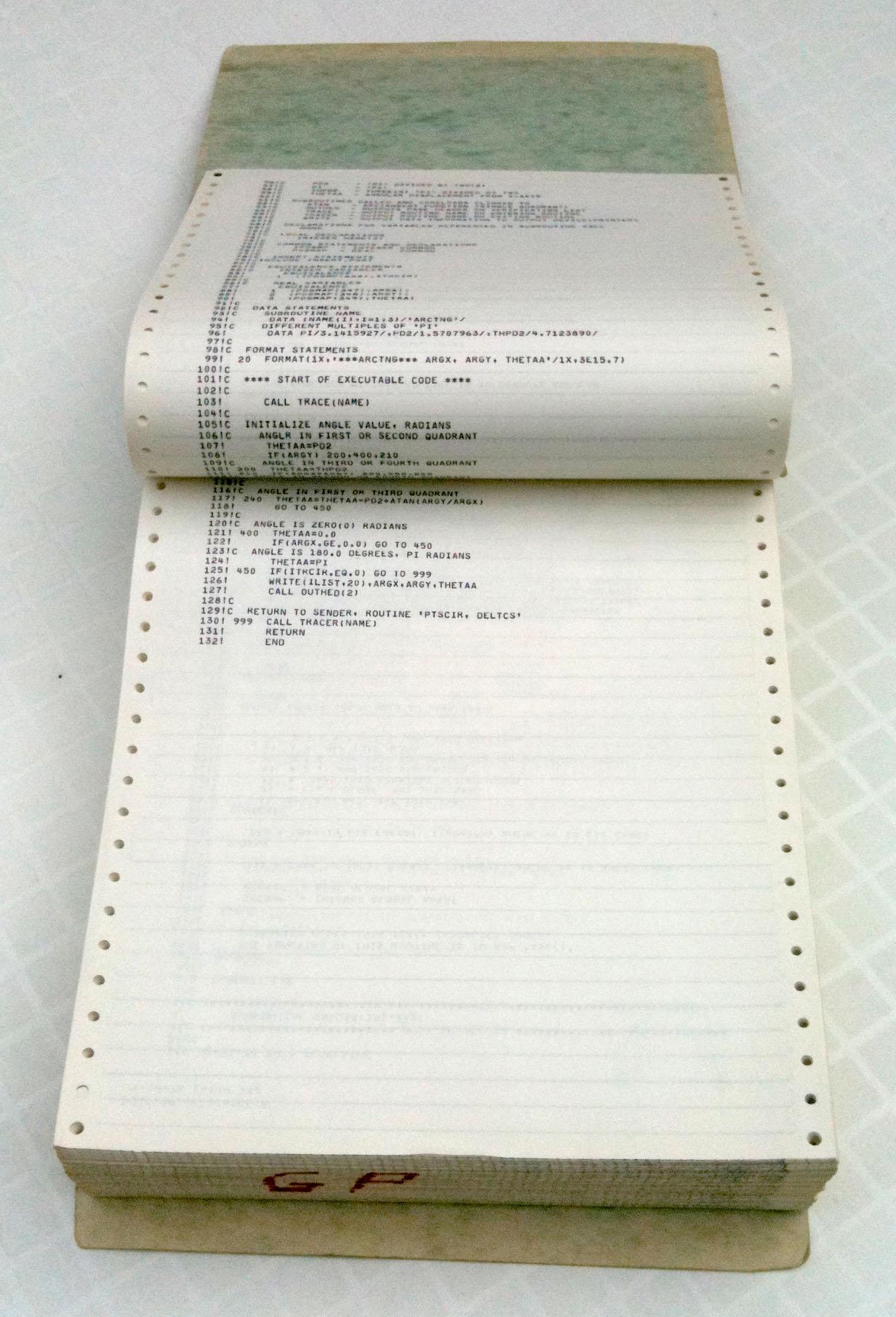 Bound stack of green-and-white-banded continuous-form computer printout