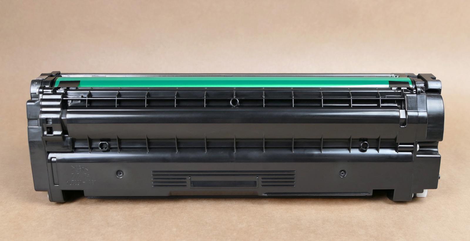 A laser printer toner cartridge photographed on a neutral background